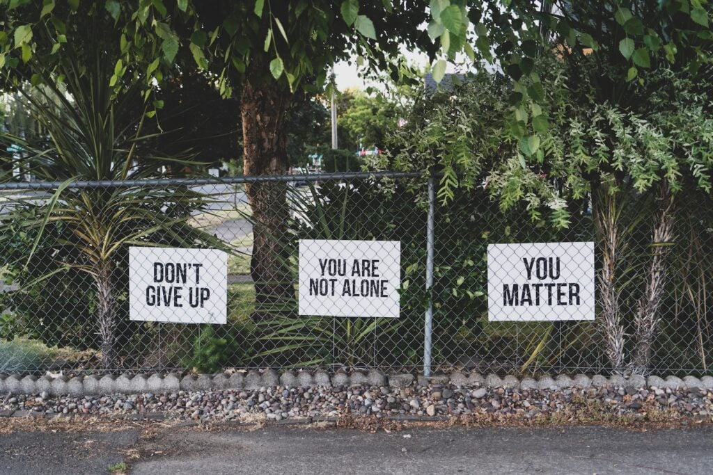 Running path with motivational signs saying 'Don't Give Up' and 'You Matter